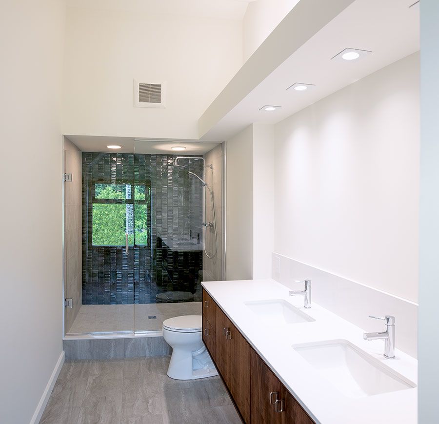Shower with green glazed tile back wall.