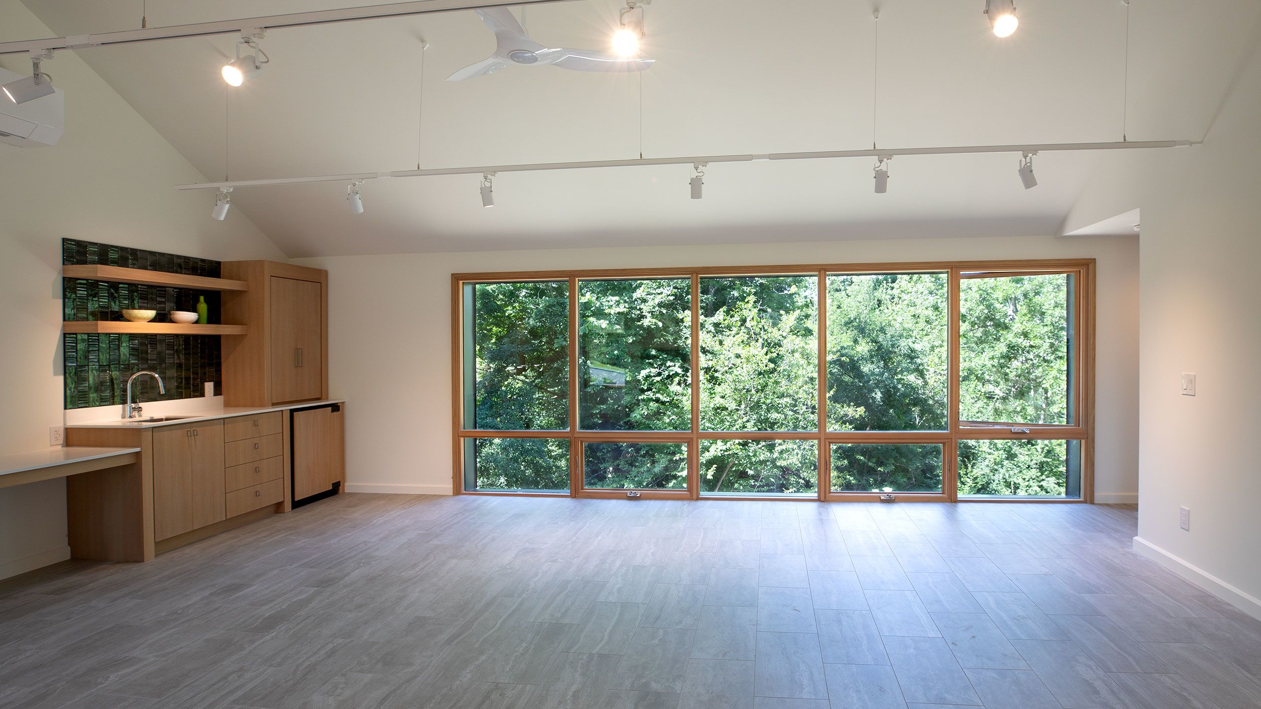 West facing view of the large window wall and trees.