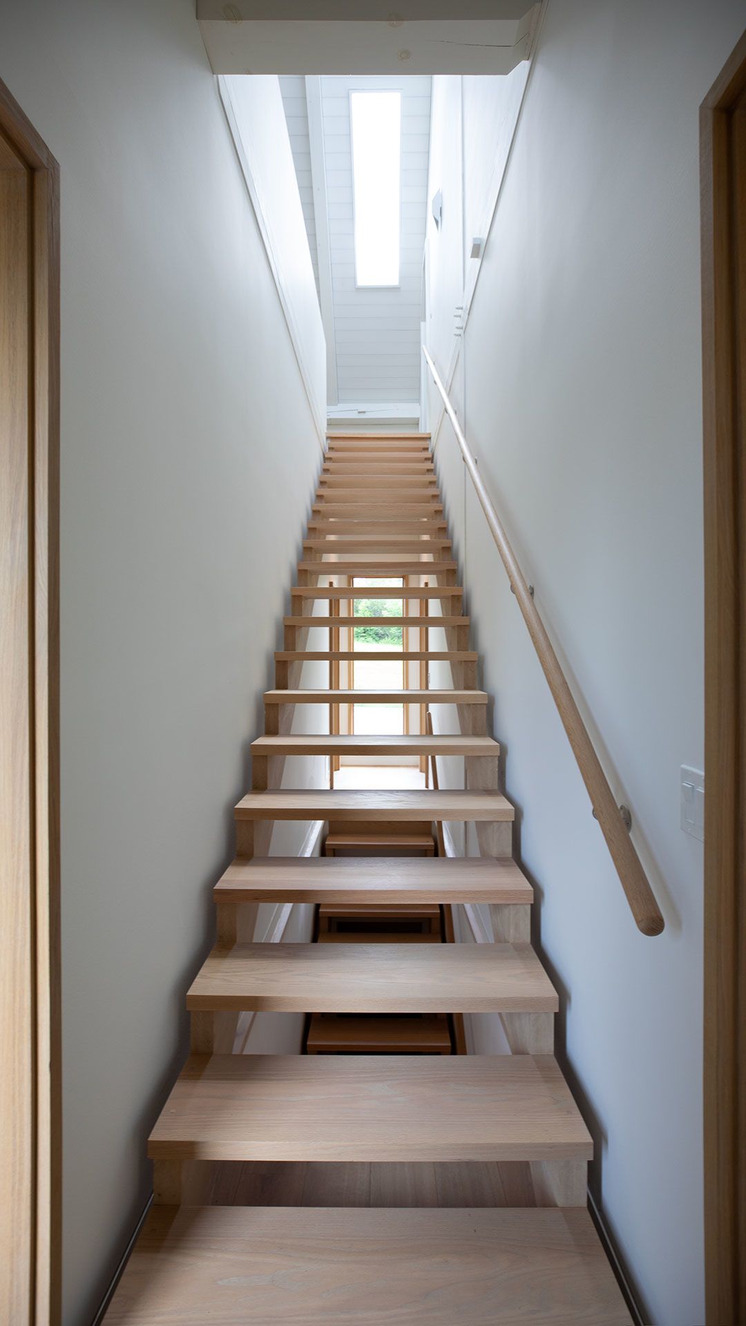 Hand-made solid red oak staircase and handrail leading to Second Level Loft