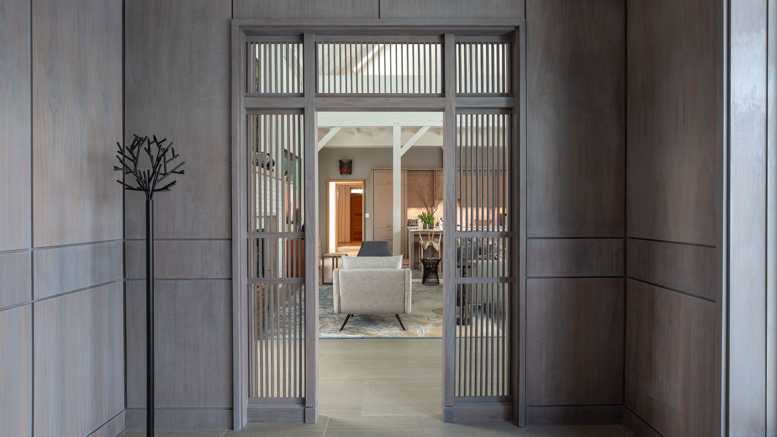 View of the Hand-finished panelled walnut Entrance Foyer with custom Doorway Screen
