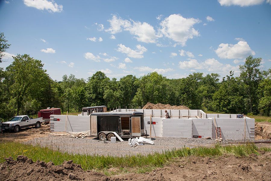 White ICF (Insulated Concrete Form) foundation panels built up upon the footings and foundation