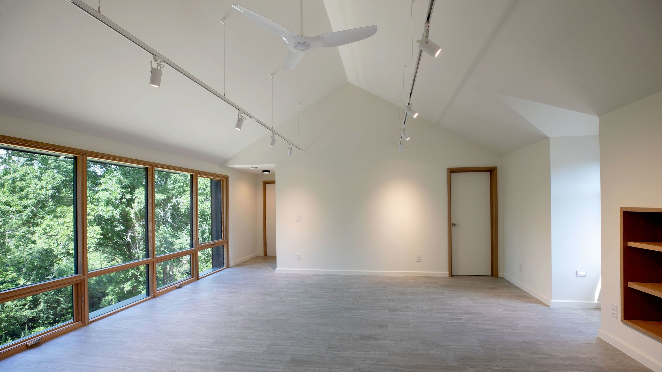 Reverse view of the Guest Suite shows a closed door to the bathroom and another door leading to the staircase.