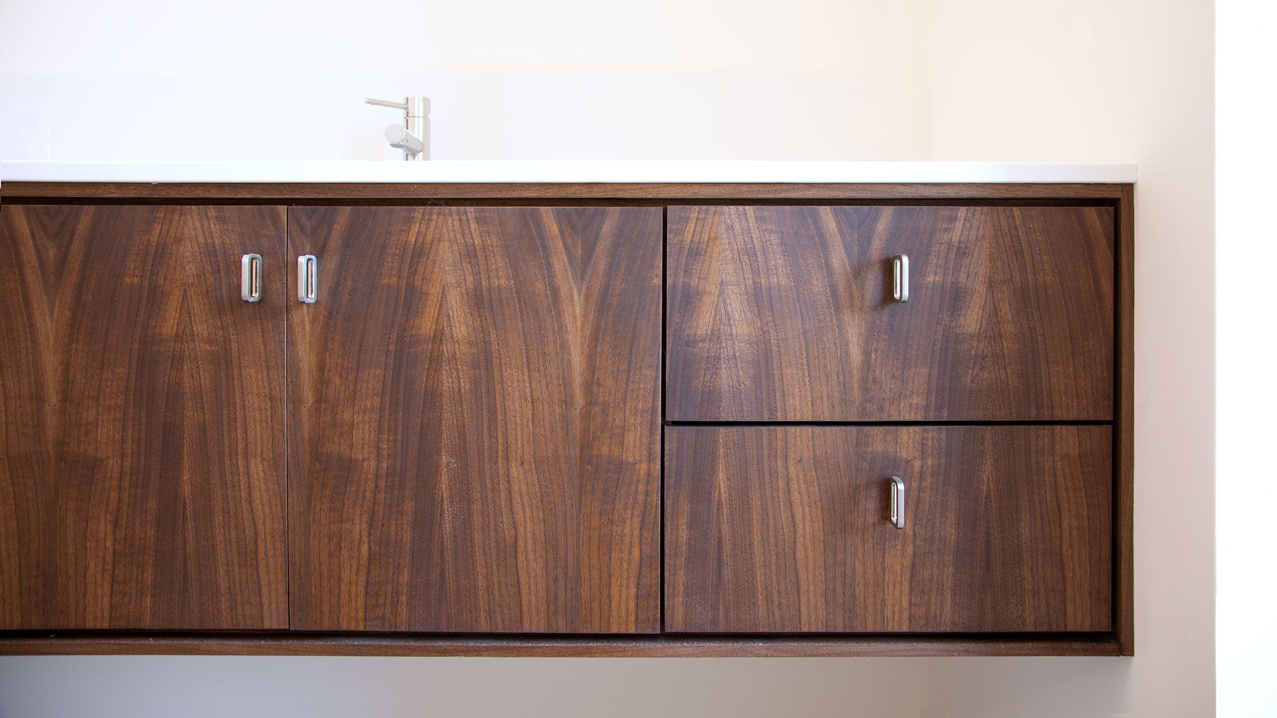 Textured detail photo of the dark walnut bathroom vanity.