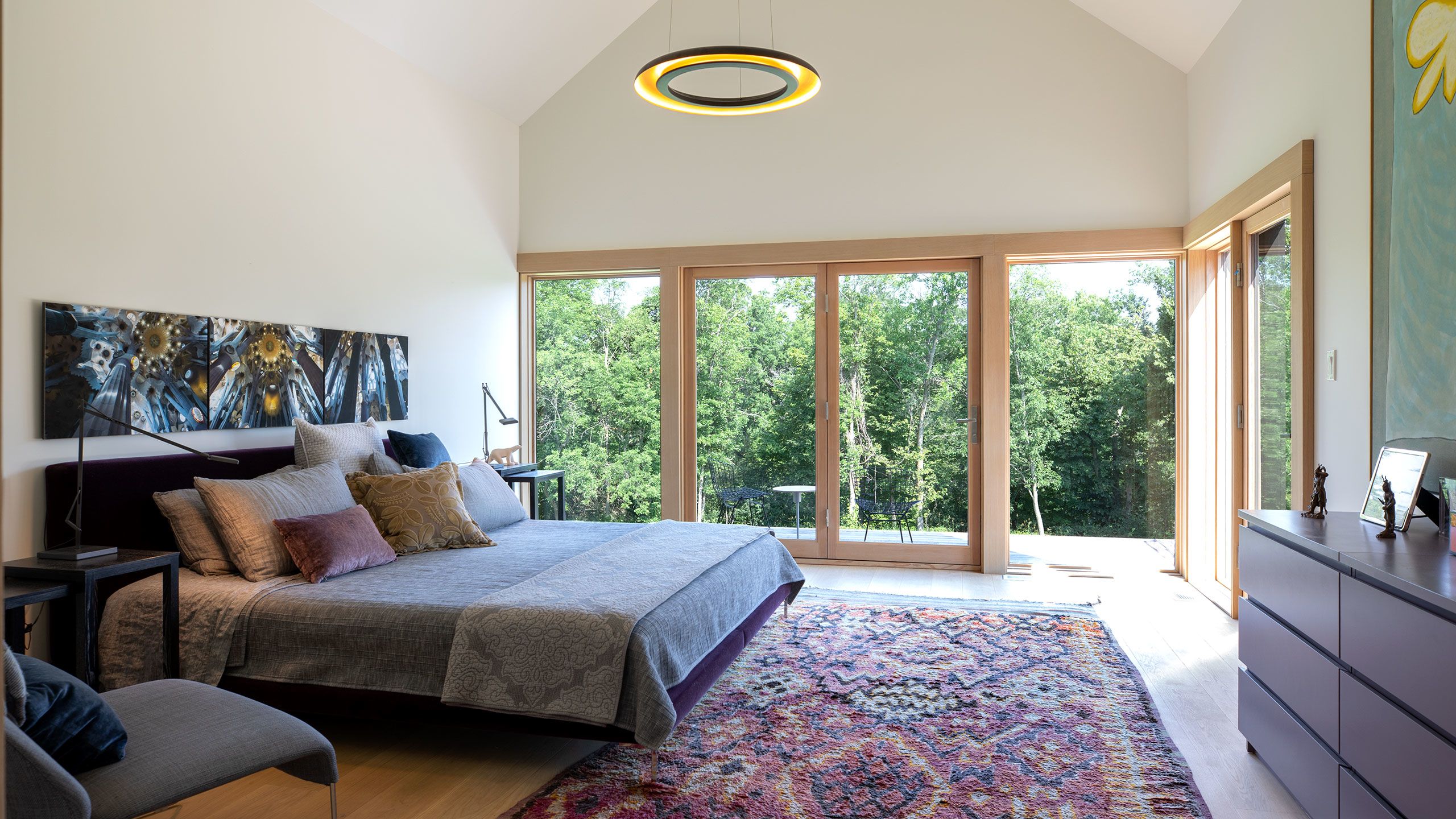 Principal Bedroom with 14 foot high cathedral ceiling and private doors opening to the deck and Napanee River views