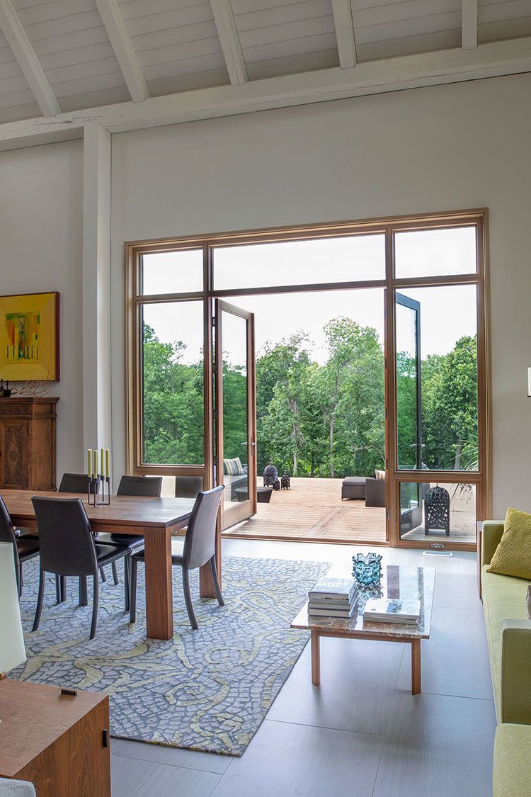 View of the living_dining area with ten foot high double doors opening onto the terrace.