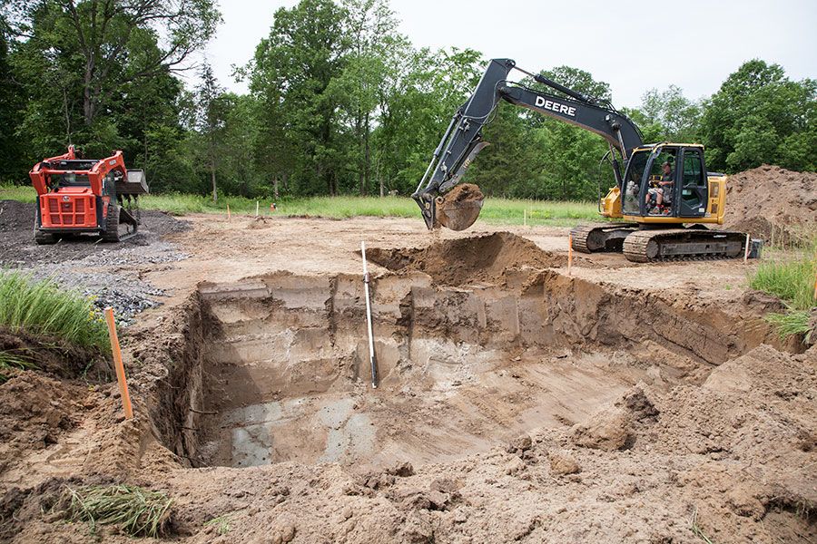Digging the hole for the foundation of the house with machines