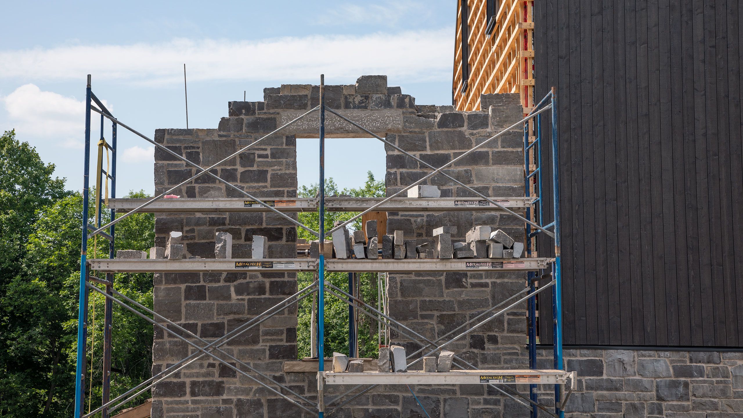 Window wall of limestone almost complete. The top of the window opening is re-enforced with a 200lb. lintel stone
