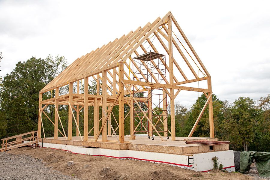 Main House timberframe skeleton assembled on a foundation 